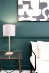 Deep teal wall paint paired with classic horizontal chair rail molding