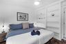 Built-in floor-to-ceiling shelving, recessed ceiling fan with integrated lighting, and tile flooring