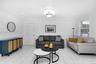 Bright interior featuring white tile flooring, decorative chair rail molding, crown molding, and a central ceiling light fixture with a medallion