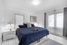 Spacious interior featuring ceramic tile flooring, crown molding, chair rail trim, and dual windows with integrated blinds
