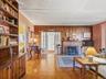 Main living room with built-ins and warm wood paneling.