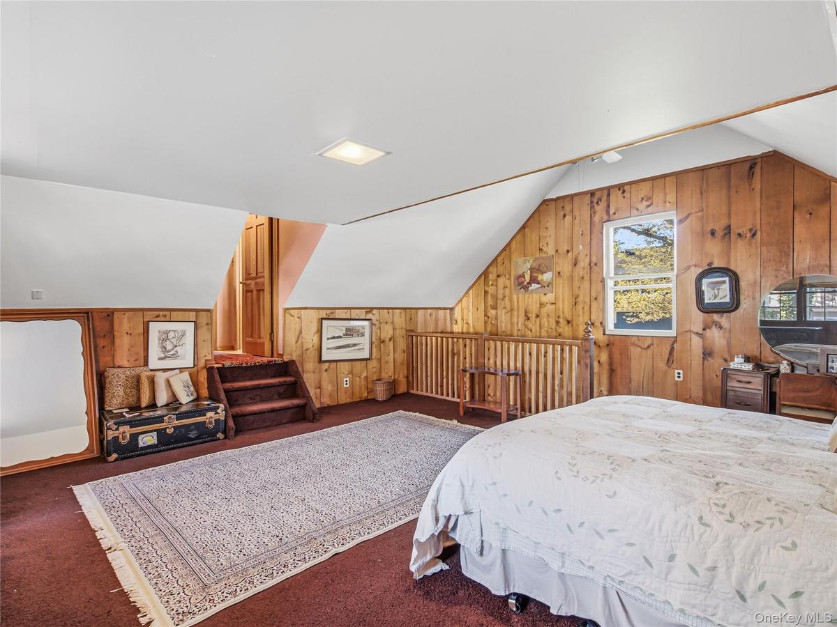 Large primary bedroom with high ceilings and loft space.