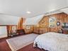 Large primary bedroom with high ceilings and loft space.