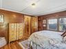 Bedroom with hardwood floors and views of the water