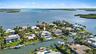 Waterfront property featuring a private boat dock, swimming pool, and direct canal access