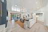 Living area featuring tongue-and-groove vaulted ceilings, wood-finish flooring, a linear fireplace with a floor-to-ceiling surround, recessed lighting