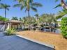 Waterfront grounds featuring a permanent timber-frame gazebo, with space for a summer kitchen and living are, a private dock, gravel hardscaping, and 
