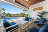 Covered patio featuring a wood-plank ceiling, horizontal siding, recessed lighting, and direct access to an inground pool and water frontage