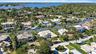Aerial perspective of waterfront properties featuring deep-water canal access, private boat docks, and established coastal vegetation