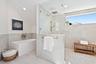 Freestanding rectangular soaking tub with wall-mounted faucet, walk-in shower with frameless glass enclosure, rainfall showerhead, and neutral large-f