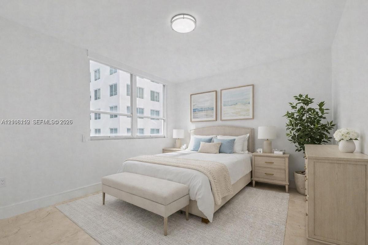 Neutral-toned walls, large multi-pane windows, and polished stone-finish flooring complemented by a flush-mount ceiling light fixture