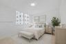 Neutral-toned walls, large multi-pane windows, and polished stone-finish flooring complemented by a flush-mount ceiling light fixture