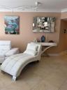 Large-format neutral tile flooring and multi-directional track lighting fixture