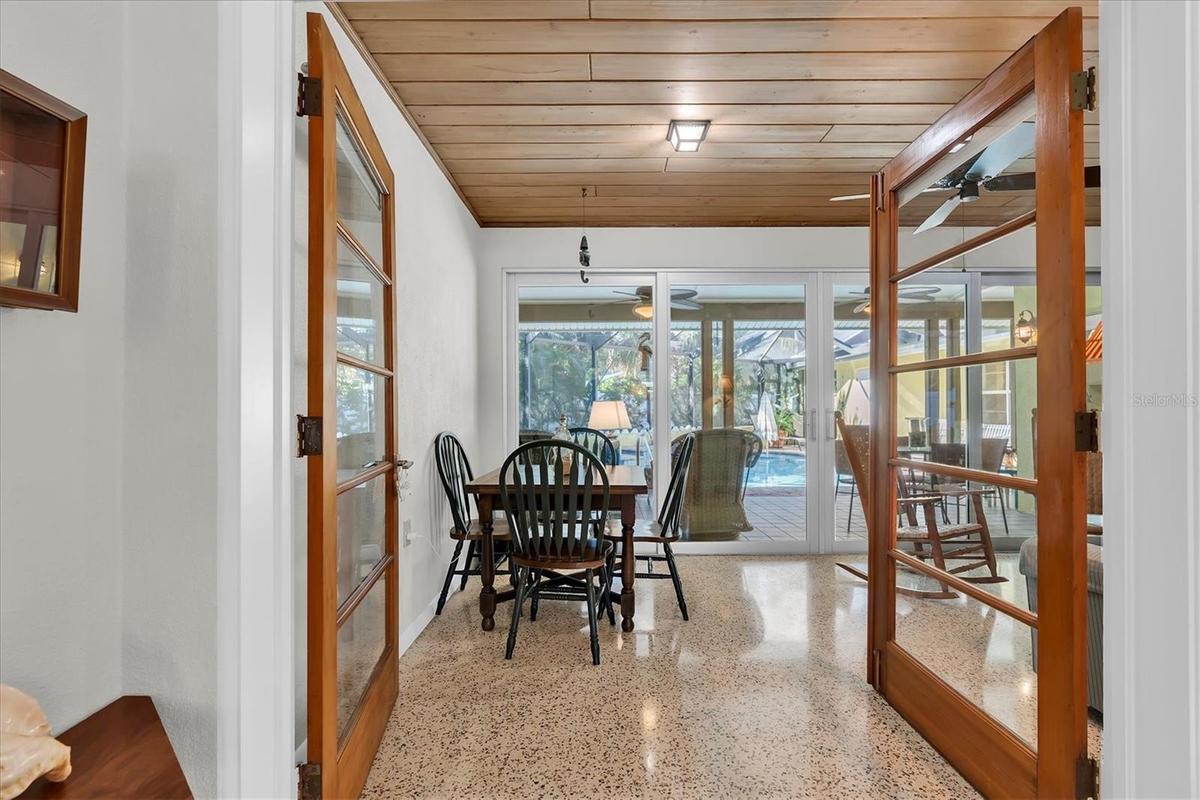 French doors open to Florida room provides extra dining and seating space overlooking the pool and spa.
