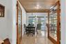 French doors open to Florida room provides extra dining and seating space overlooking the pool and spa.