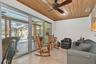 Sliders off Florida room open to large covered outdoor dining, cooking and entertaining space