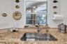 Kitchen sink overlooks lanai and pool and spa area. New garbage disposal in 5/25.
