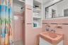 The pink bath is an en-suite for the second bedroom.