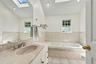 Spacious bathroom with separate shower and whirlpool tub.