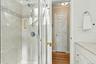 Separate shower with ceramic tiling.