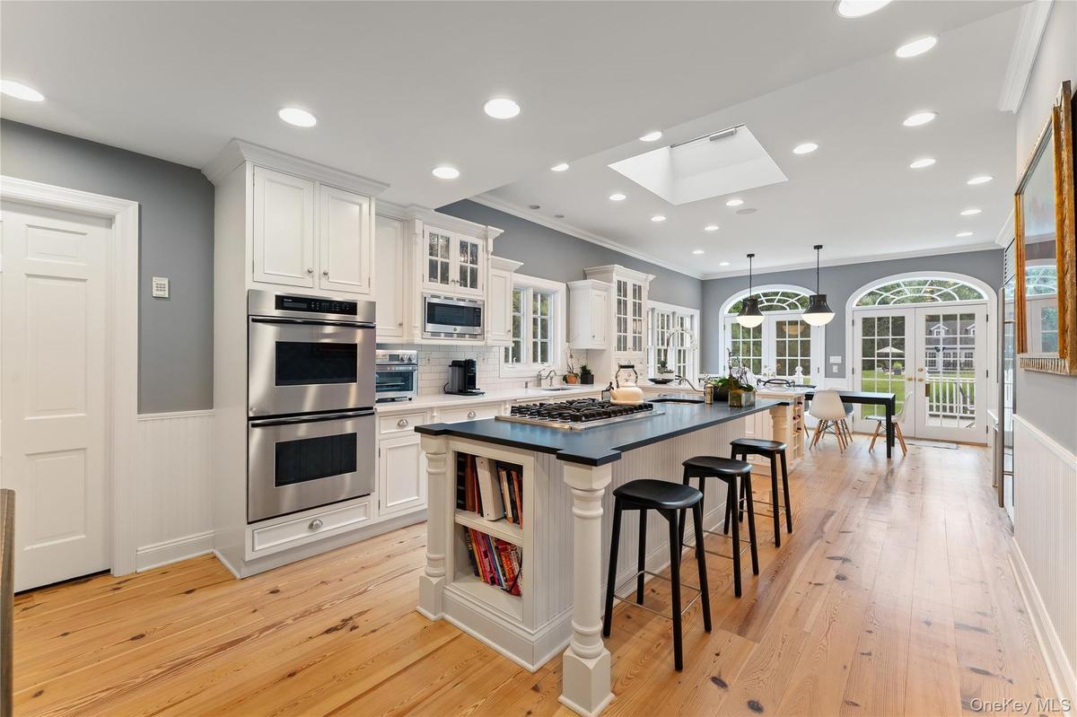 Chefs kitchen, high ceiling, French doors to expansive deck and property