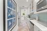 Full kitchen, electric stove top, dishwasher, refrigerator, marble counter tops, glass backsplash