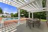Fabulous pergola and bluestone patio outside of pool house