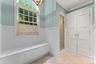 Guest changing area with stand alone shower, linen closet