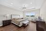 Tray ceiling with recessed lighting, central drum chandelier, and wood-finish flooring