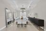 Tray ceiling featuring recessed lighting, polished tile flooring, and a central tiered crystal chandelier