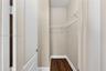 Walk-in closet featuring neutral wall tones, wood-finish flooring, and white wire shelving