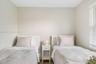 Neutral wall palette, wood-finish flooring, and horizontal window blinds