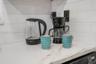 Quartz countertop featuring veined detailing and a white subway tile backsplash
