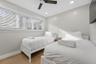Neutral-toned interior featuring wood-finish flooring, a ceiling fan with integrated lighting, recessed lighting, and horizontal window blinds