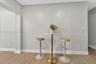 Neutral wall tones paired with wood-finish flooring