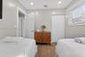 Neutral-toned room featuring wood-finish flooring, recessed lighting, and a closet with double-panel doors