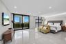 Covered balcony featuring large-format tile flooring and a glass panel railing