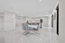 Open-concept interior featuring large-format tile flooring, recessed ceiling lighting, and built-in cabinetry with integrated wine storage