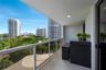 Custom built-in light-tone cabinetry, integrated wall-mounted desk, recessed LED lighting, and neutral large-format tile flooring