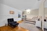 Neutral wall tones, wood-finish flooring, and a large wall-mounted mirror