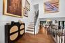 Foyer featuring a high ceiling, wood-finish flooring, and a staircase with wood treads and a black metal railing