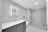 Customized walk-in closet featuring floor-to-ceiling built-in shelving, a central storage island with soft-close drawers, recessed ceiling lighting, a