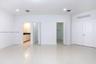 Neutral interior featuring large-format tile flooring, recessed ceiling lighting, two walk-in closets, and dual-panel interior doors