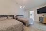 Vaulted ceiling featuring a modern multi-globe chandelier and large-format tile flooring