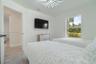 Neutral interior featuring large-format tile flooring, a geometric multi-point chandelier, and a single-pane window