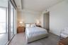 Floor-to-ceiling glass sliding doors, neutral tile flooring, recessed ceiling lighting, and smooth-finish interior walls