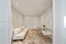 Neutral-toned interior space featuring recessed ceiling lighting, wood-finish flooring, and two interior doors
