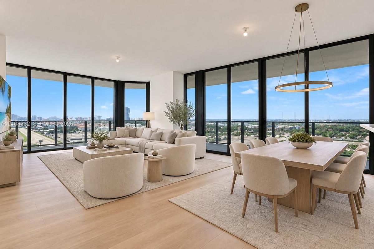 Floor-to-ceiling windows, wood-finish flooring, recessed lighting, and a circular metal-frame pendant light fixture