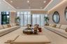 Floor-to-ceiling windows with floor-length drapery, recessed tray ceiling with integrated cove lighting, recessed overhead lighting, and light-toned h