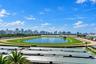 Panoramic skyline outlook featuring a sprawling racetrack, central lake, and lush green grounds